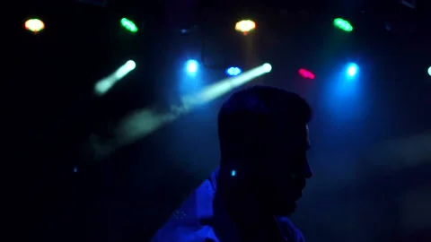 Modern young guy dances in the dark in a nightclub Stock Footage 86163568