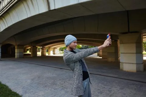 Modern young man with tablet pc under a bridge Stock Photos
