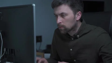 Modern young man working remotely from home at night. Concentrated businessman Stock Footage 162477923