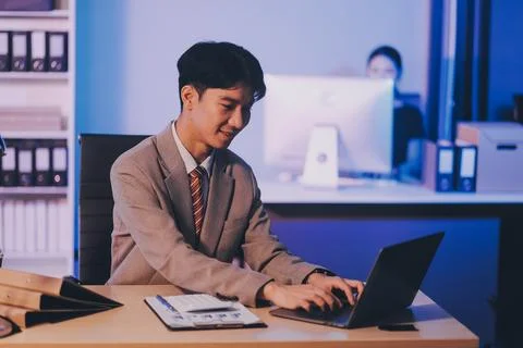 Modern young man working remotely from home at night. Stock Photos