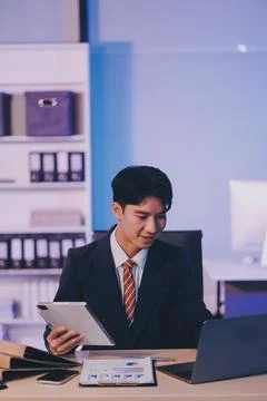 Modern young man working remotely from home at night. Stock Photos