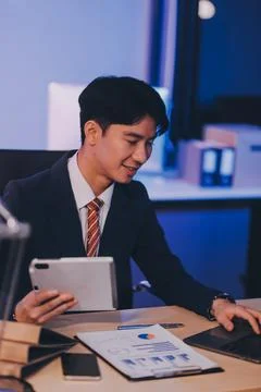 Modern young man working remotely from home at night. Stock Photos