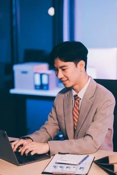 Modern young man working remotely from home at night. 스톡 사진