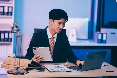 Modern young man working remotely from home at night. 스톡 사진