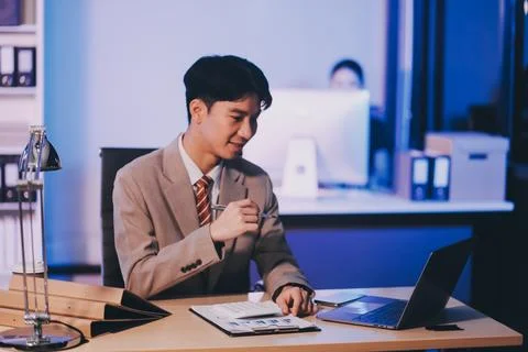 Modern young man working remotely from home at night. 스톡 사진