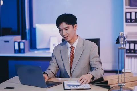 Modern young man working remotely from home at night. 스톡 사진