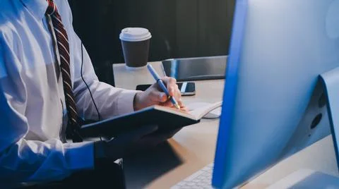 Modern young man working remotely from home at night. 스톡 사진