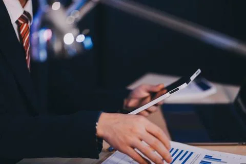 Modern young man working remotely from home at night. 写真素材