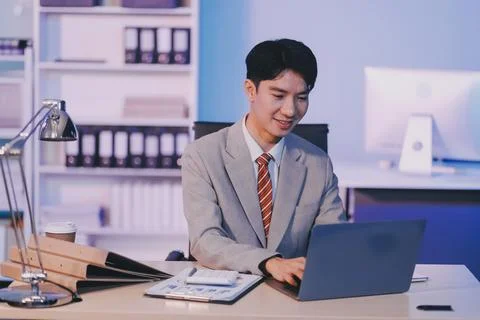 Modern young man working remotely from home at night. 스톡 사진