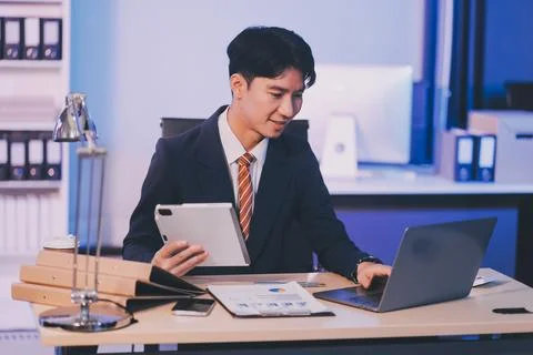 Modern young man working remotely from home at night. 스톡 사진