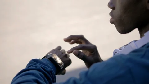 Modernity,technology,watch. Young african man using smart watch-close up Video stock 98594014