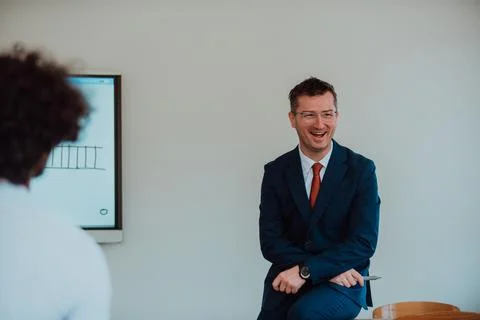 A modernly dressed professor engages in educating Stock Photos