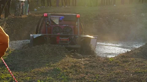 A modified 4x4 SUV participating in an extreme off-road race Stock Footage 345496238