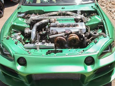 Modified chrome engine bay of a green custom tuning car at a show in Ruston.. Stock Photos