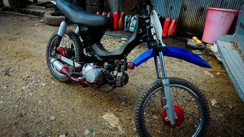 Modified Dirt Bike in Workshop Setting Stock Photos