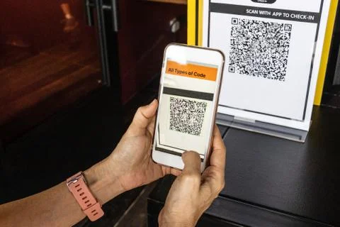 Modified inactive QR Code used. Person scanning QR code with smartphone to re Stock Photos
