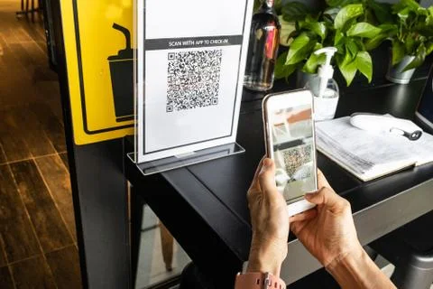 Modified inactive QR Code used. Person scanning QR code with smartphone to re Stock Photos