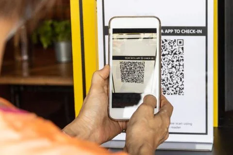 Modified inactive QR Code used. Person scanning QR code with smartphone to re Stock Photos