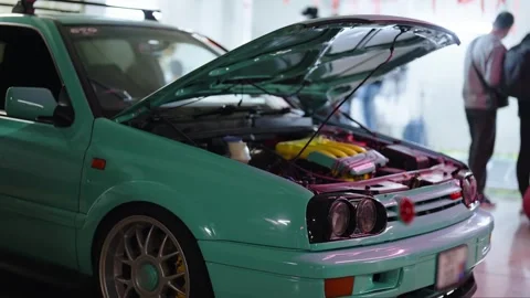Modified Volkswagen Golf engine displayed at a custom car show Stock Footage 329282697