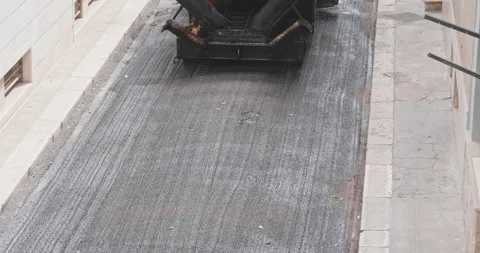 Modugno, Italy - May 2022: Workers with an asphalt machine during asphalt res Video stock 202203315