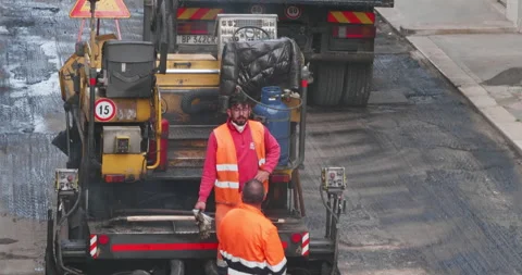 Modugno, Italy - May 2022: Workers with an asphalt machine during asphalt res Video stock 202203325
