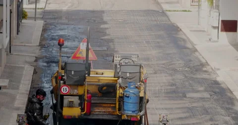 Modugno, Italy - May 2022: Workers with an asphalt machine during asphalt res Video stock 202203408