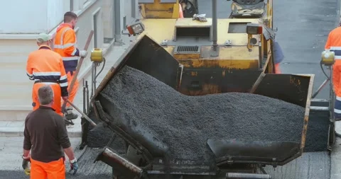 Modugno, Italy - May 2022: Workers with an asphalt machine during asphalt res Stock-Footage 247628691