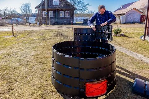 Modular assembly of panel compost bin, gardener snap together segmented dur.. Stock Photos