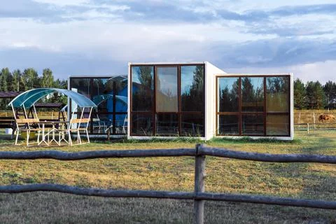Modular house with large panoramic windows and a gazebo in the countryside Stock Photos
