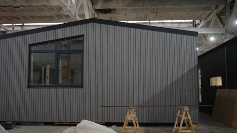Modular house under construction in a large warehouse Video stock 313089176