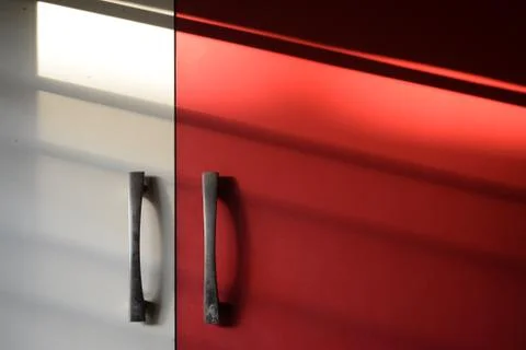 Modular Kitchen cupboard in white and red with sunlight Stock Photos