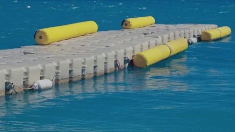 A modular plastic dock snakes through the waves Stock Footage 322512190