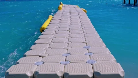 A modular plastic dock snakes through the waves Stock Footage 322512206