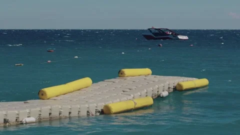 A modular plastic dock snakes through the waves Stock Footage 322512394