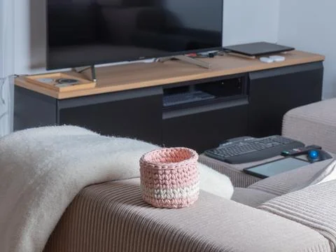 A modular sectional sofa and separate ottoman in light, wide-ribbed corduro.. Stock Photos