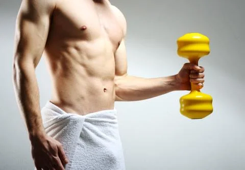 Modybuilder doing heavy weight exercise with dumbbells against dark backgroun Stock Photos