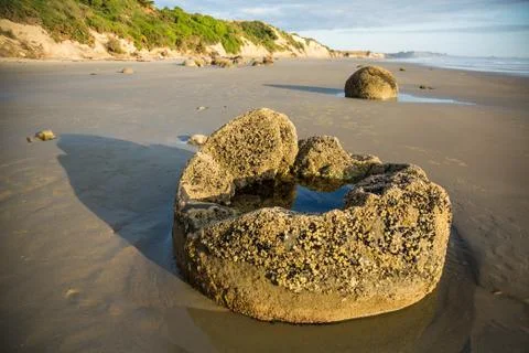 Moeraki Boulder tidal pool on sandy beach Stock Photos