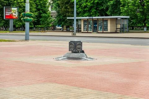Mogilev, Belarus. Zero Kilometer monument, a dark granite cube with bronze .. Stock Photos