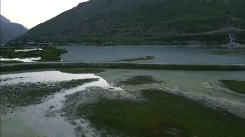 Moiry Glacier Sunrise Close Orbit Descent Over Lake Stock Footage 323378539