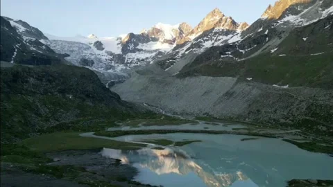 Moiry Glacier Sunrise Reverse Ascend Reveal Mirror Lake and Mountains Stock Footage 323379984