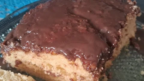 Moist chocolate glazed sponge cake slice in smooth motion video clip Stock Footage 339247399