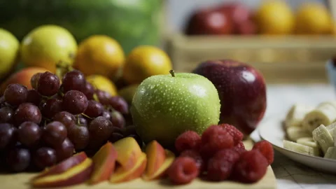 Moist, delicious looking fruit on plates in kitchen - tracking shot Stock Footage 341192552