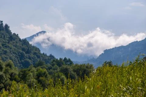 Moisture in the form of a pair of mountains rising into the clouds, mountain Fotos Stock