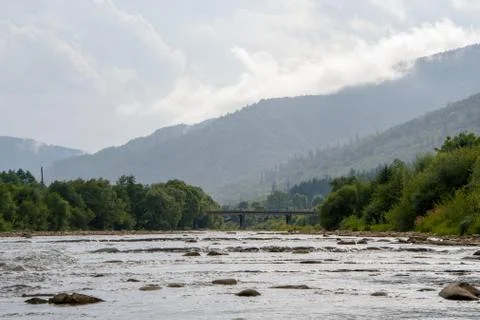 Moisture in the form of steam rises from the top of the mountain into clouds Foto stock