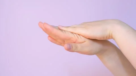Moisturizing cream on female hand on light pink background, skin care concept. Stock Footage 244639295