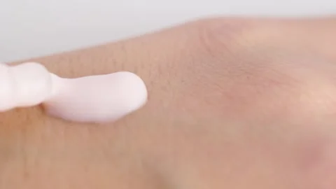 Moisturizing serum lotion in peach fuzz colour in pipette falling at the wo.. Stock Footage 258917124