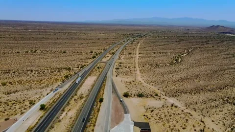Mojave Desert Drone over Highway during the afternoon with Mountains Stock Footage