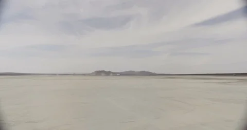 Mojave Dry Lake Bed Wide Shot Zoom In to Dust in Background Stock Footage 89941597