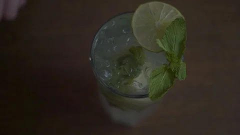 Mojito is decorated with a circle of lime and a sprig of mint Stock Footage 93970603