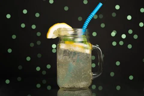 Mojito in a jar with a pipe on a dark background and bokeh Stock Photos